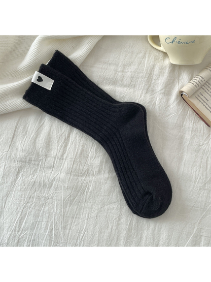 Black ribbed crew socks with a heart label