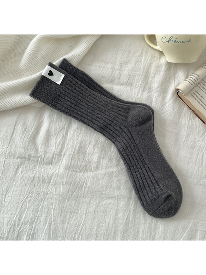 Dark gray ribbed crew socks with a heart label