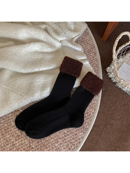 Black ribbed crew socks with brown fuzzy fold-over cuffs