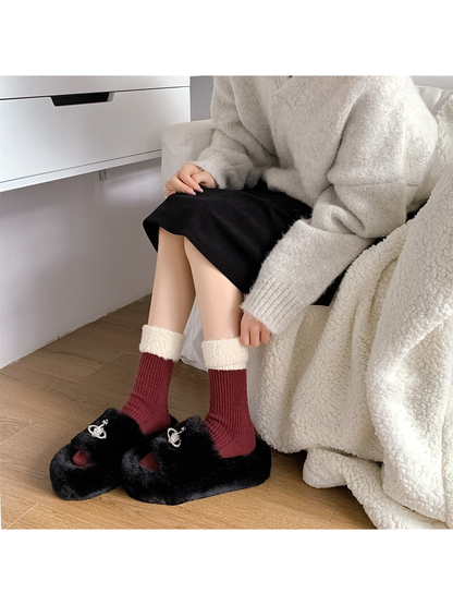 Burgundy contrast-cuff crew socks worn with black plush slippers