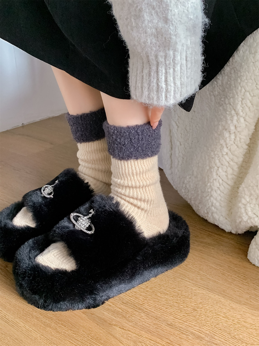 Cream contrast-cuff crew socks worn with black plush slippers