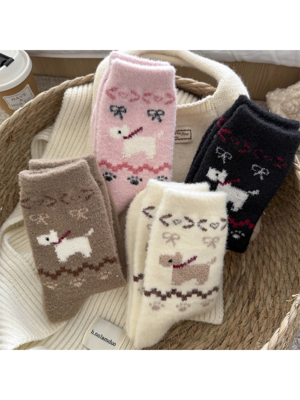 Four colors of fuzzy dog-motif crew socks arranged in a woven basket