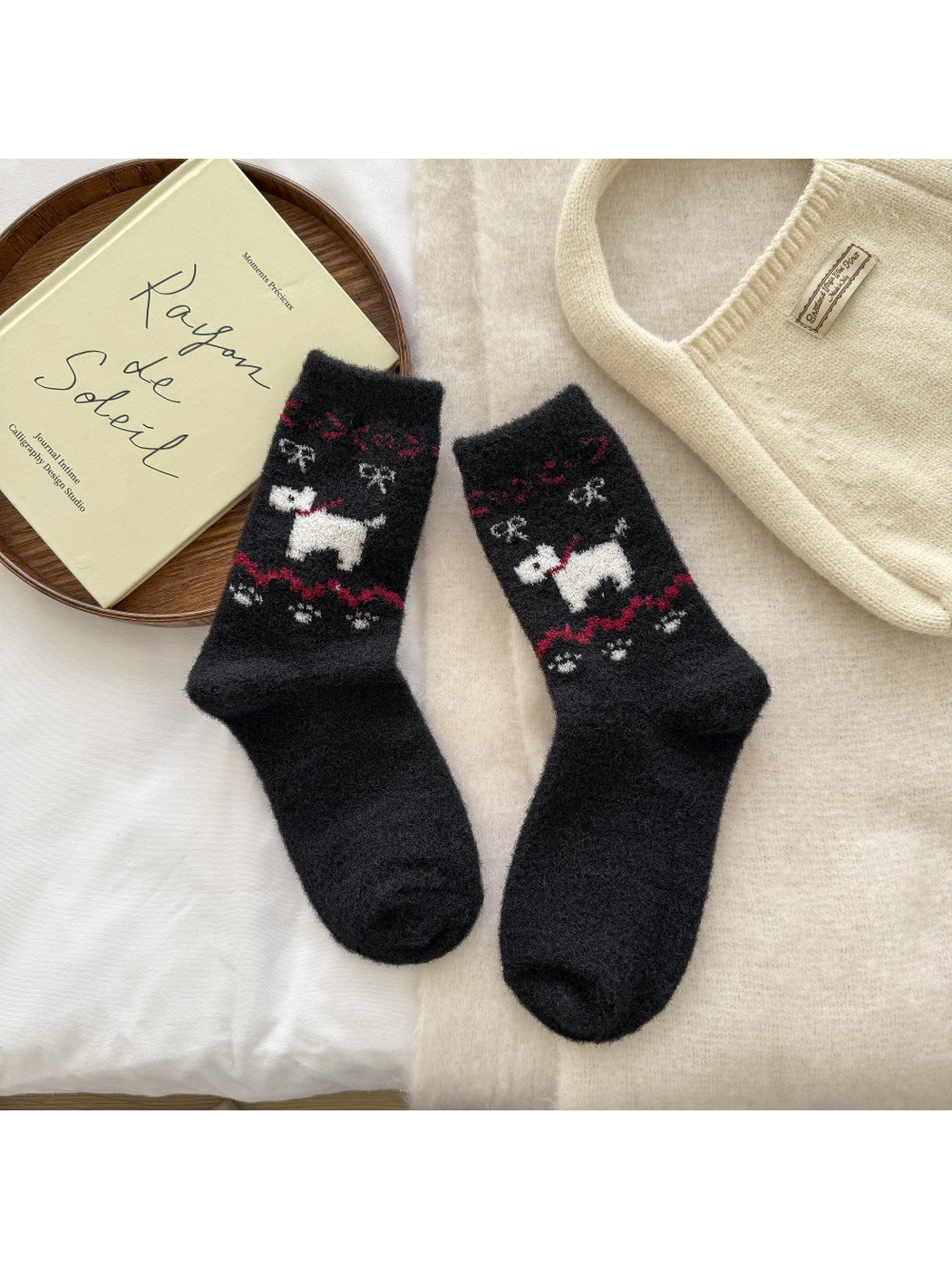 Black fuzzy crew socks with a white dog motif and red decorative bands
