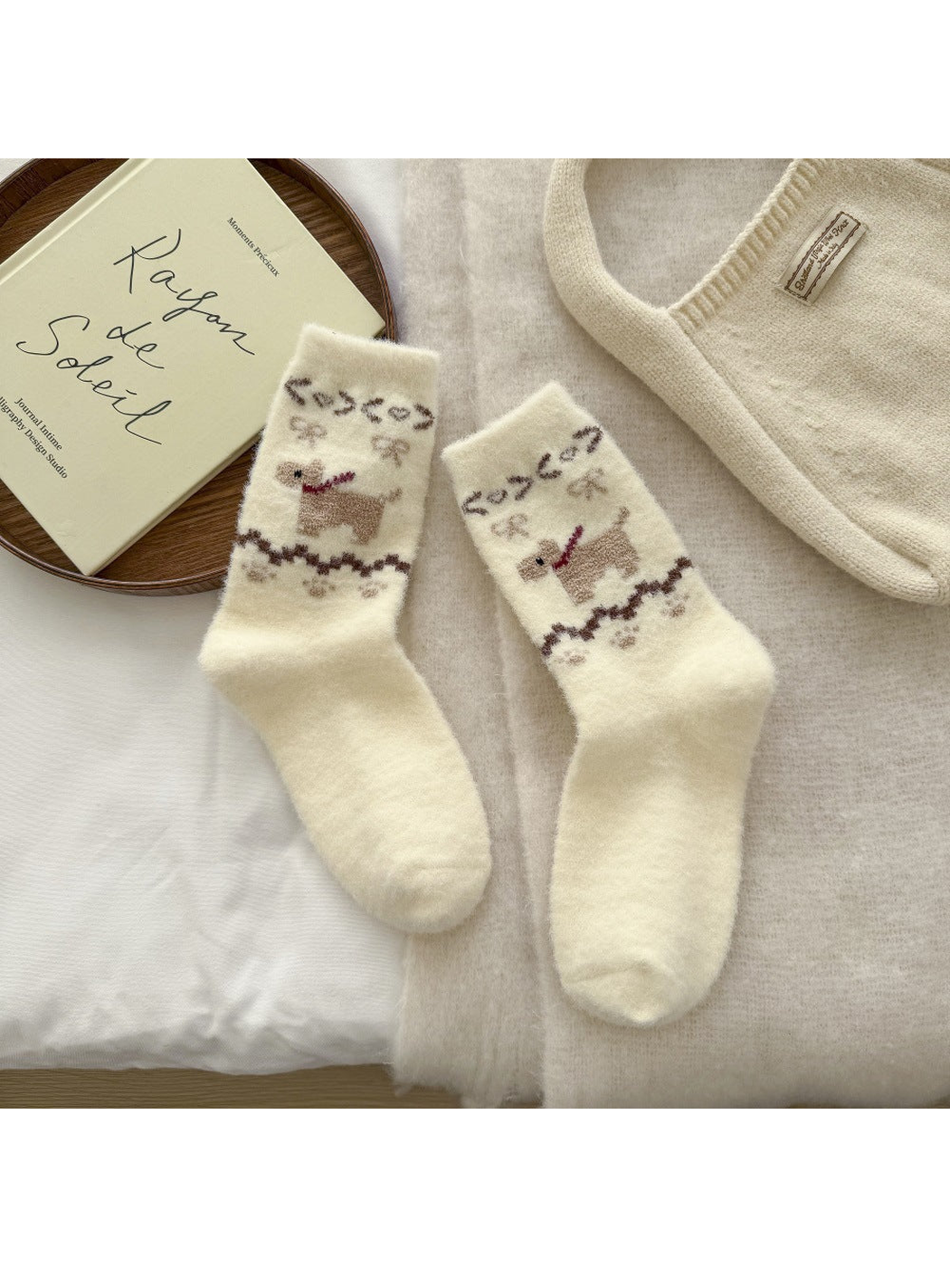 Ivory fuzzy crew socks with a tan dog motif and decorative ankle bands