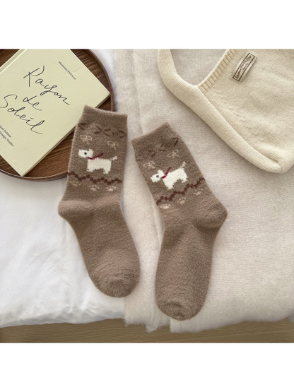 Brown fuzzy crew socks with a white dog motif and decorative ankle bands