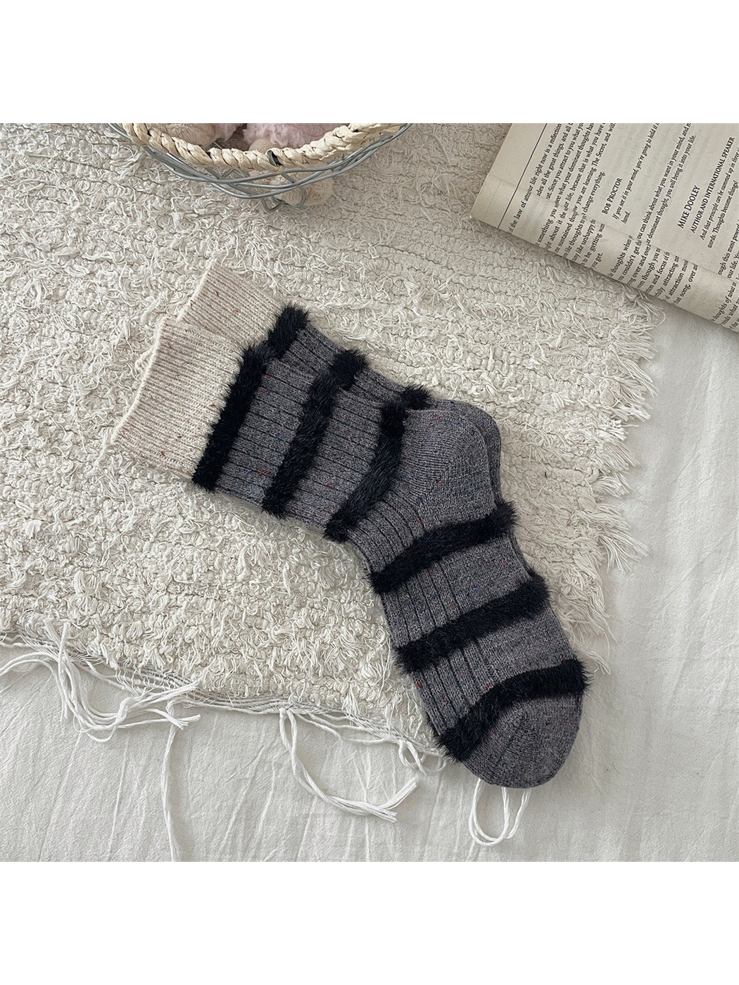 Dark gray crew socks with cream cuffs and black fuzzy stripes