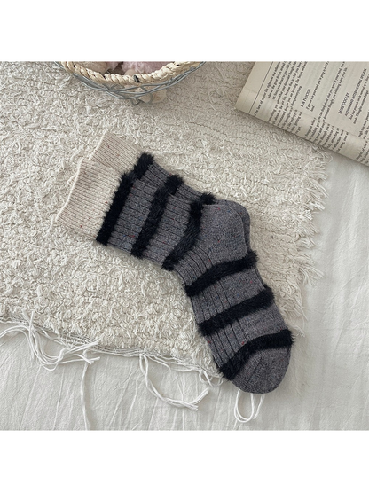Dark gray crew socks with cream cuffs and black fuzzy stripes