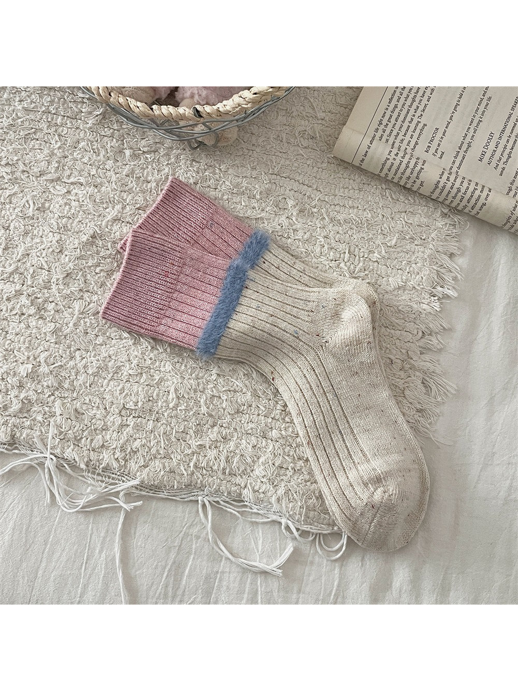 Cream speckled crew socks with pink cuffs and blue fuzzy trim