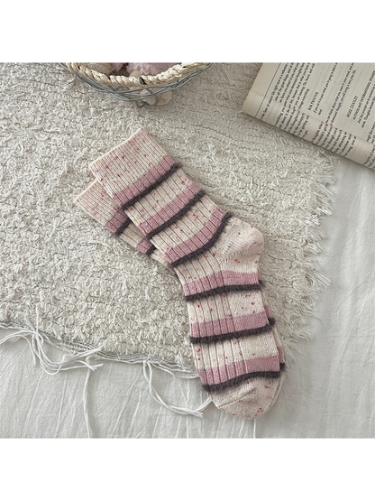Cream and pink striped crew socks with fuzzy dark trim
