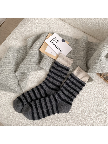 Dark gray crew socks with black fuzzy stripes and ivory cuffs