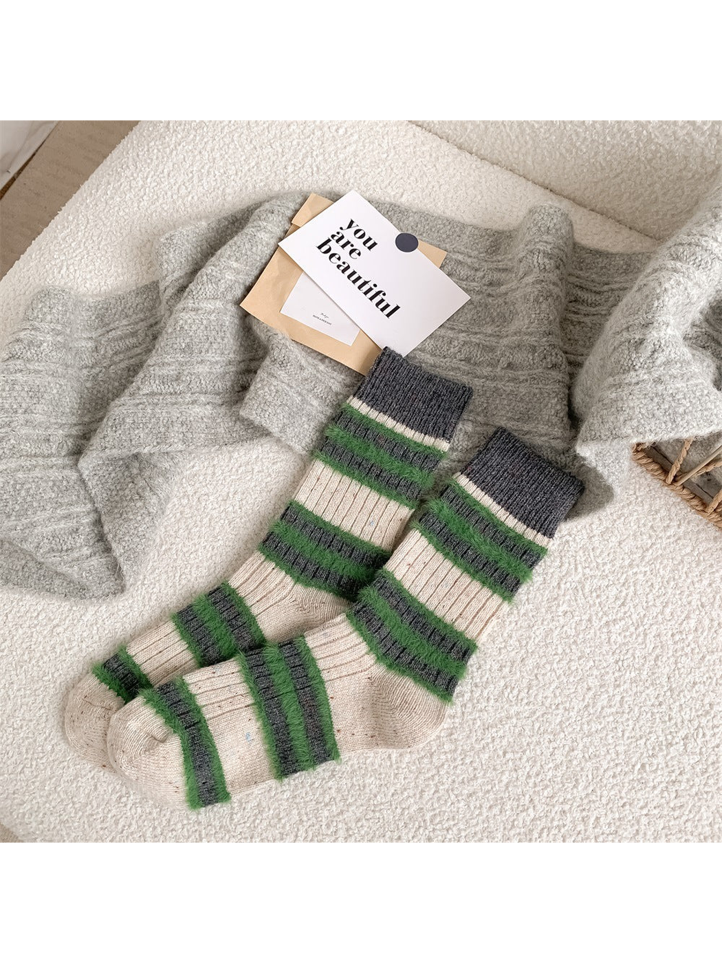Ivory crew socks with green and dark gray fuzzy stripes