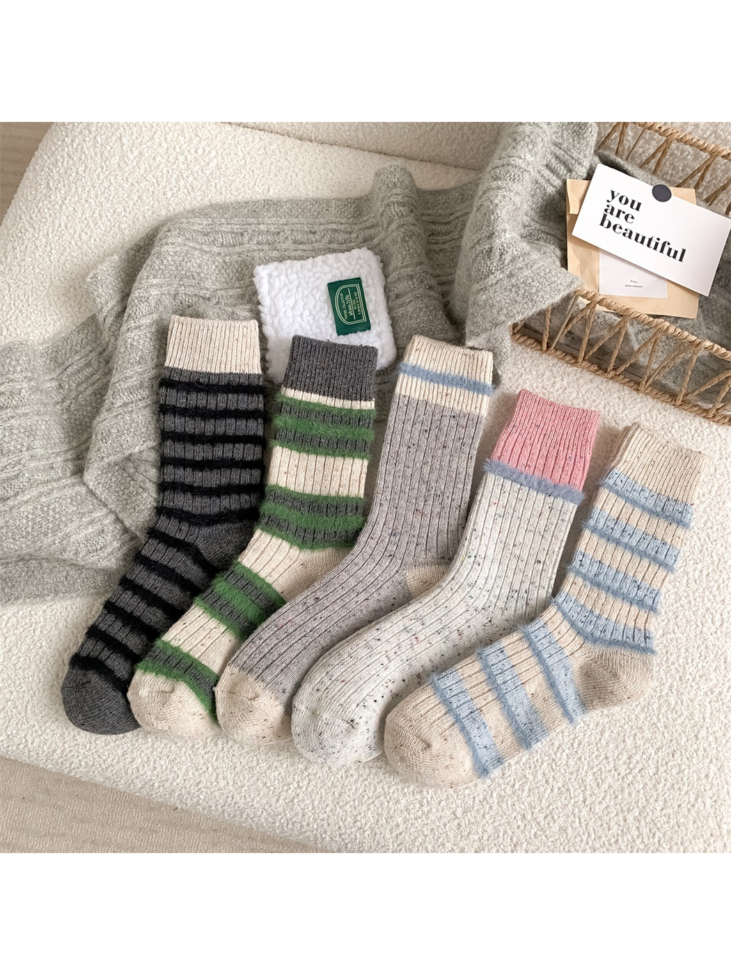 Five crew sock styles arranged together on a textured chair