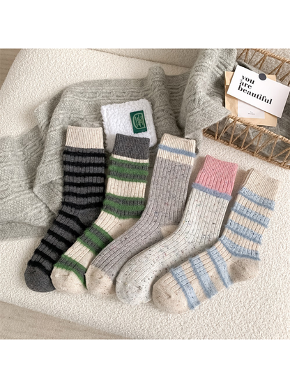 Five crew sock styles arranged together on a textured chair