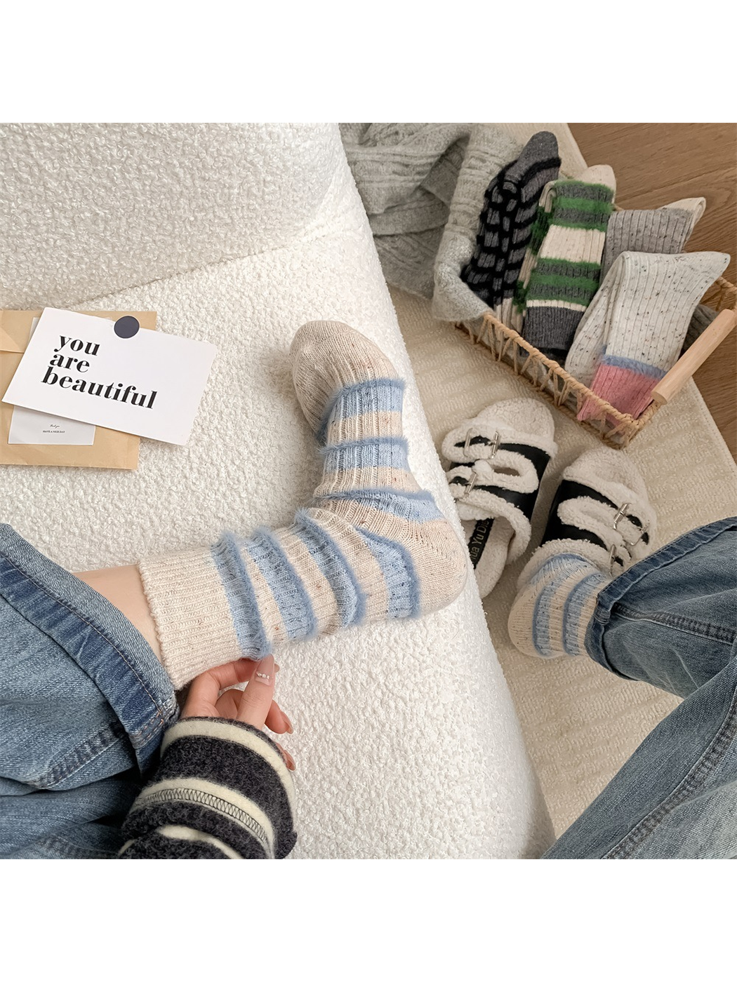 Pale blue striped crew socks worn in a relaxed indoor setting
