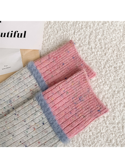 Close-up of pink ribbed cuffs with pale blue fuzzy trim