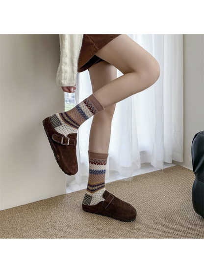 Brown geometric crew socks worn with brown clogs