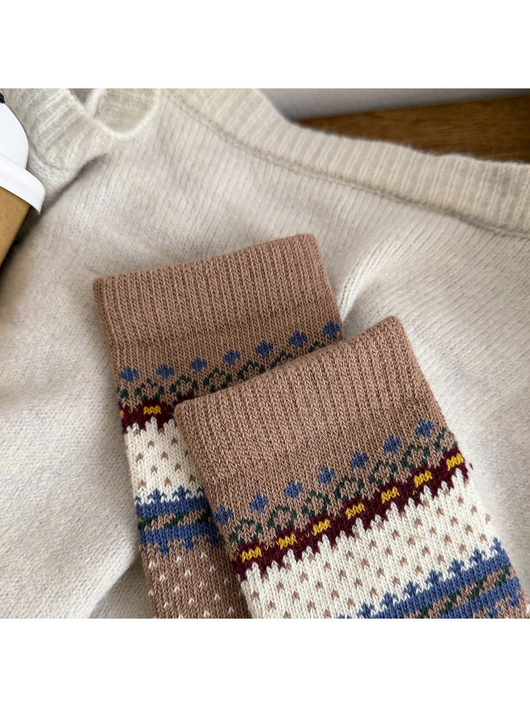 Close-up of the brown ribbed cuff and small blue geometric motifs