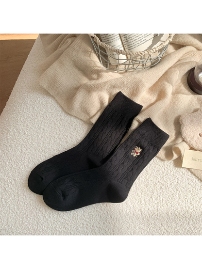 Black cable-knit crew socks with embroidered animal motif