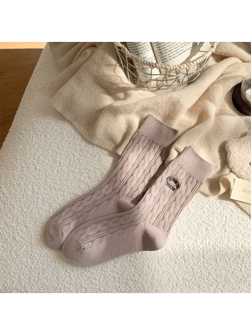 Light taupe cable-knit crew socks with embroidered text motif