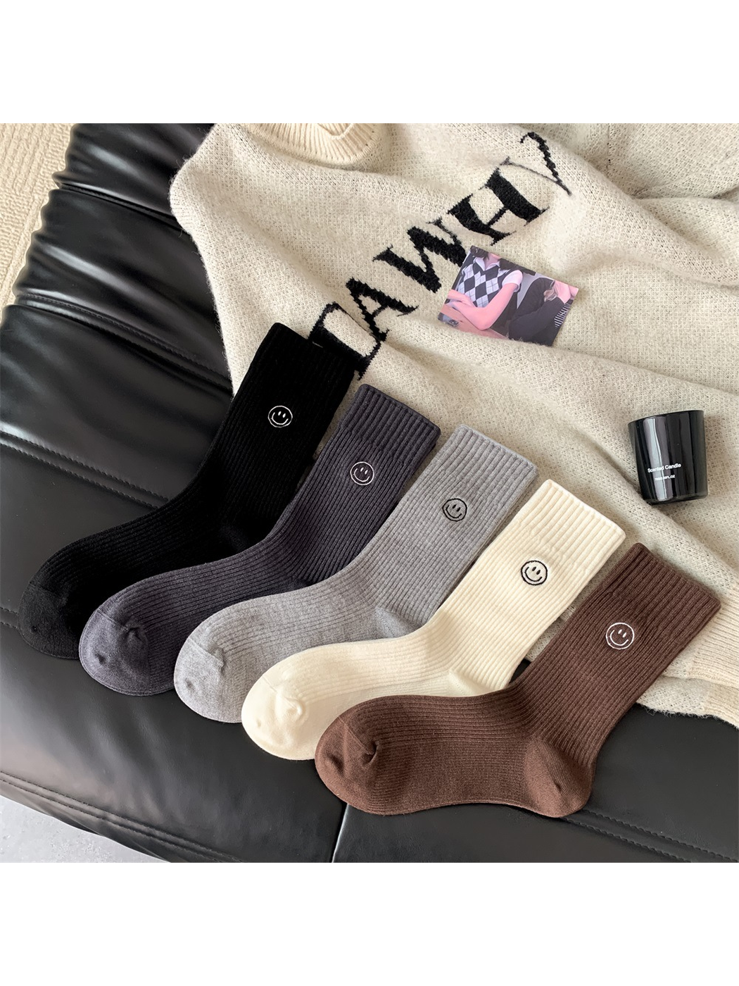 Five color variants of ribbed crew socks with embroidered smiley motifs
