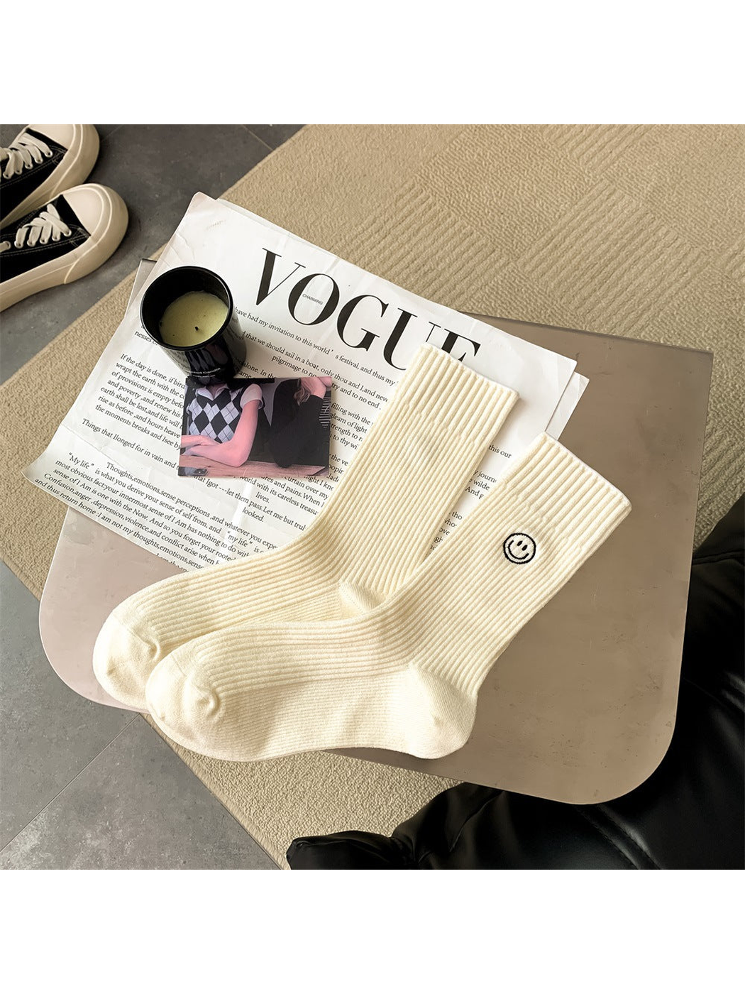 Cream ribbed crew socks with embroidered smiley motif, pair laid flat