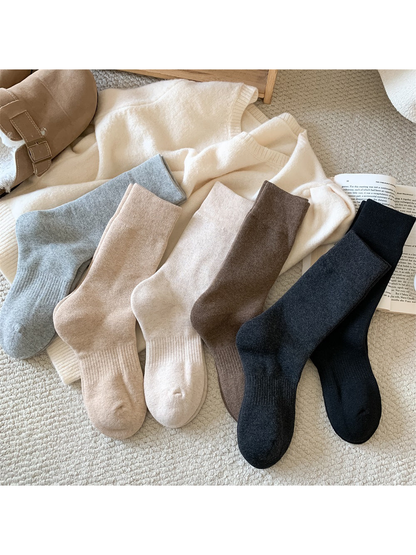 Solid-color crew socks displayed in six neutral shades