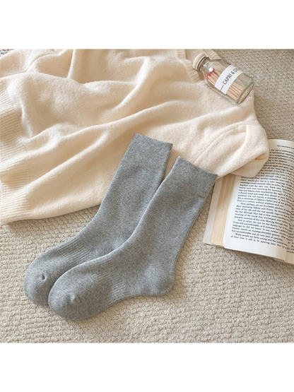 Light gray solid-color crew socks with ribbed cuffs