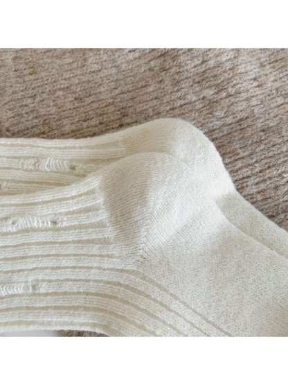 Close-up of the cream sock heel and ribbed upper