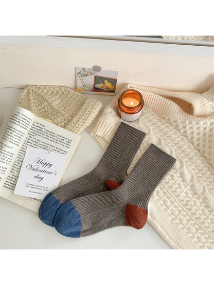 Dark gray ribbed crew socks with blue toes and rust heels