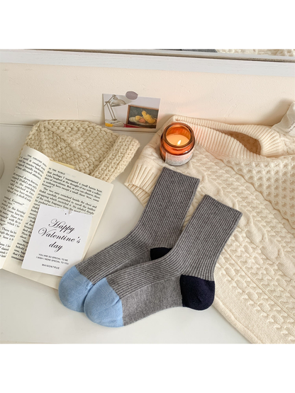 Light gray ribbed crew socks with pale blue toes and navy heels