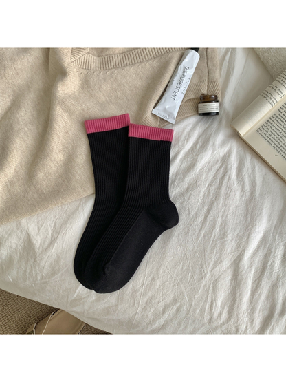 Black ribbed crew socks with rose-pink cuff bands