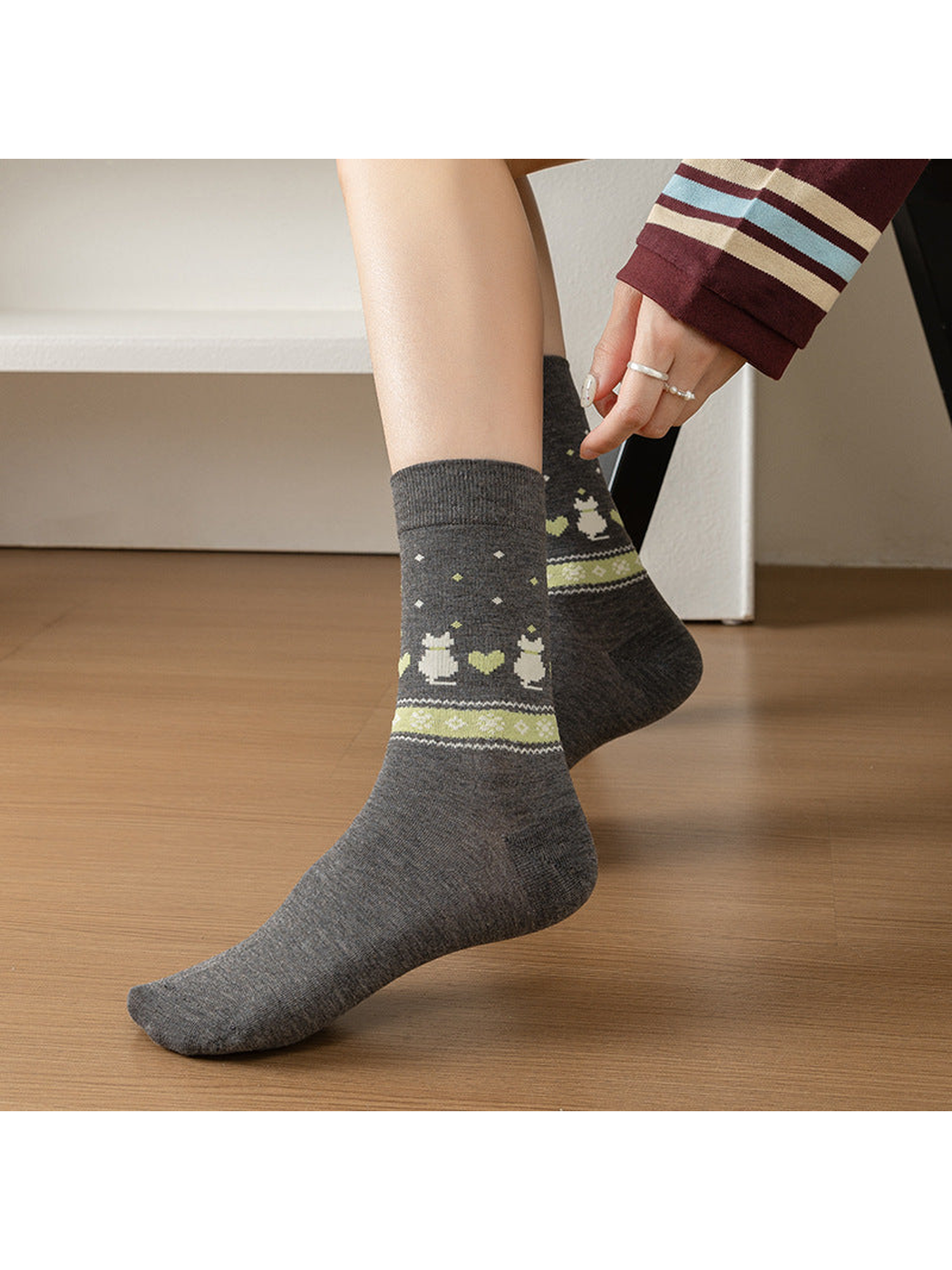 Gray rabbit and heart crew socks being pulled on