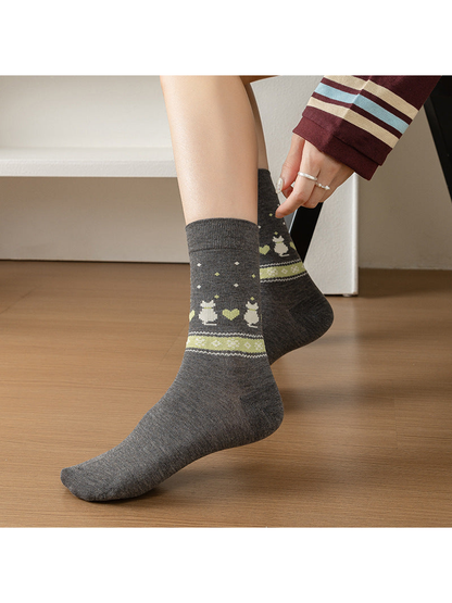 Gray rabbit and heart crew socks being pulled on