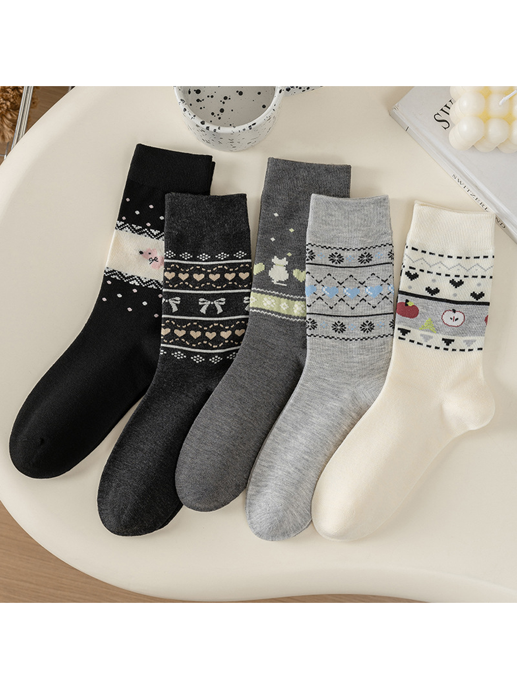 Five patterned crew sock styles arranged on a tabletop