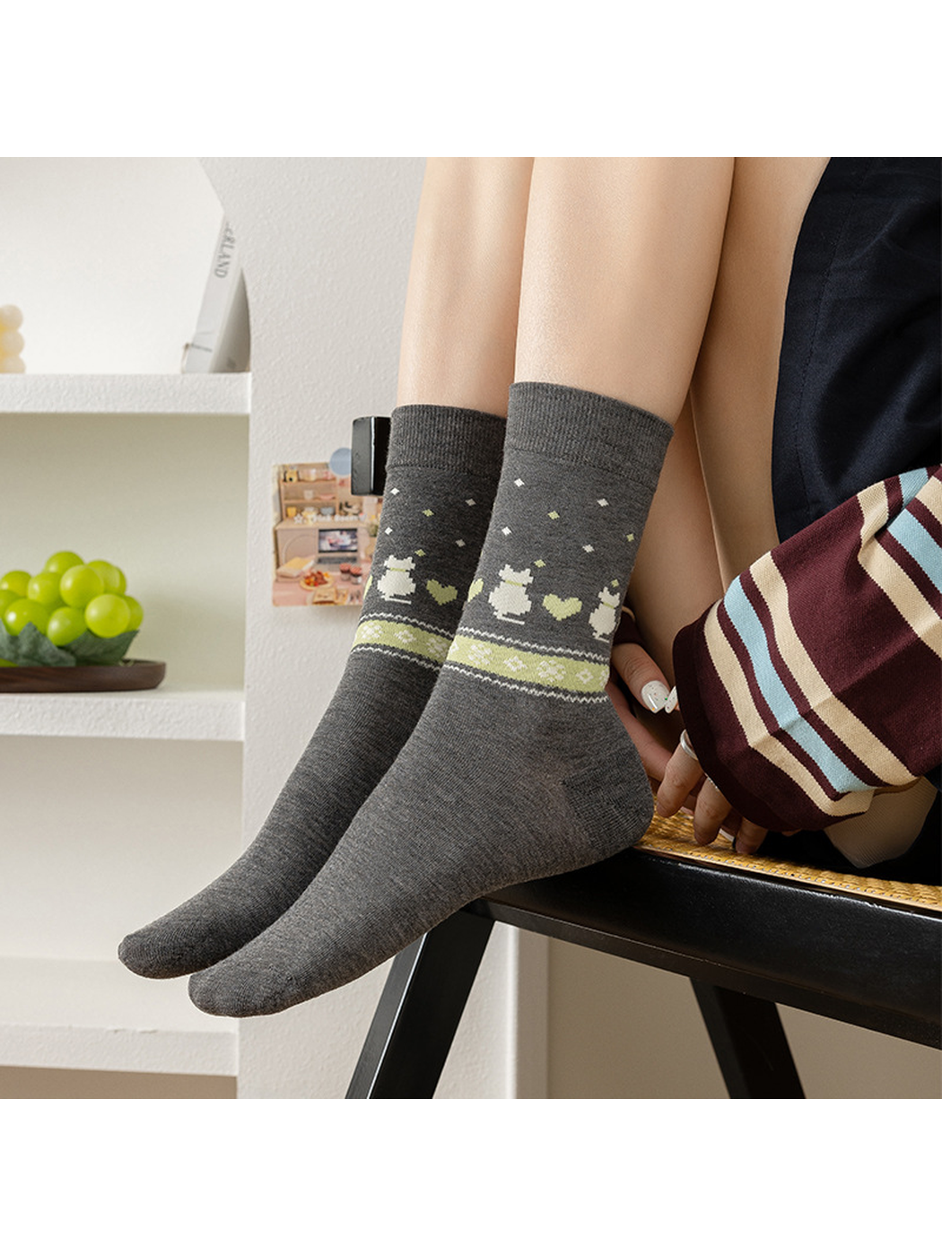 Gray rabbit and heart crew socks worn while seated
