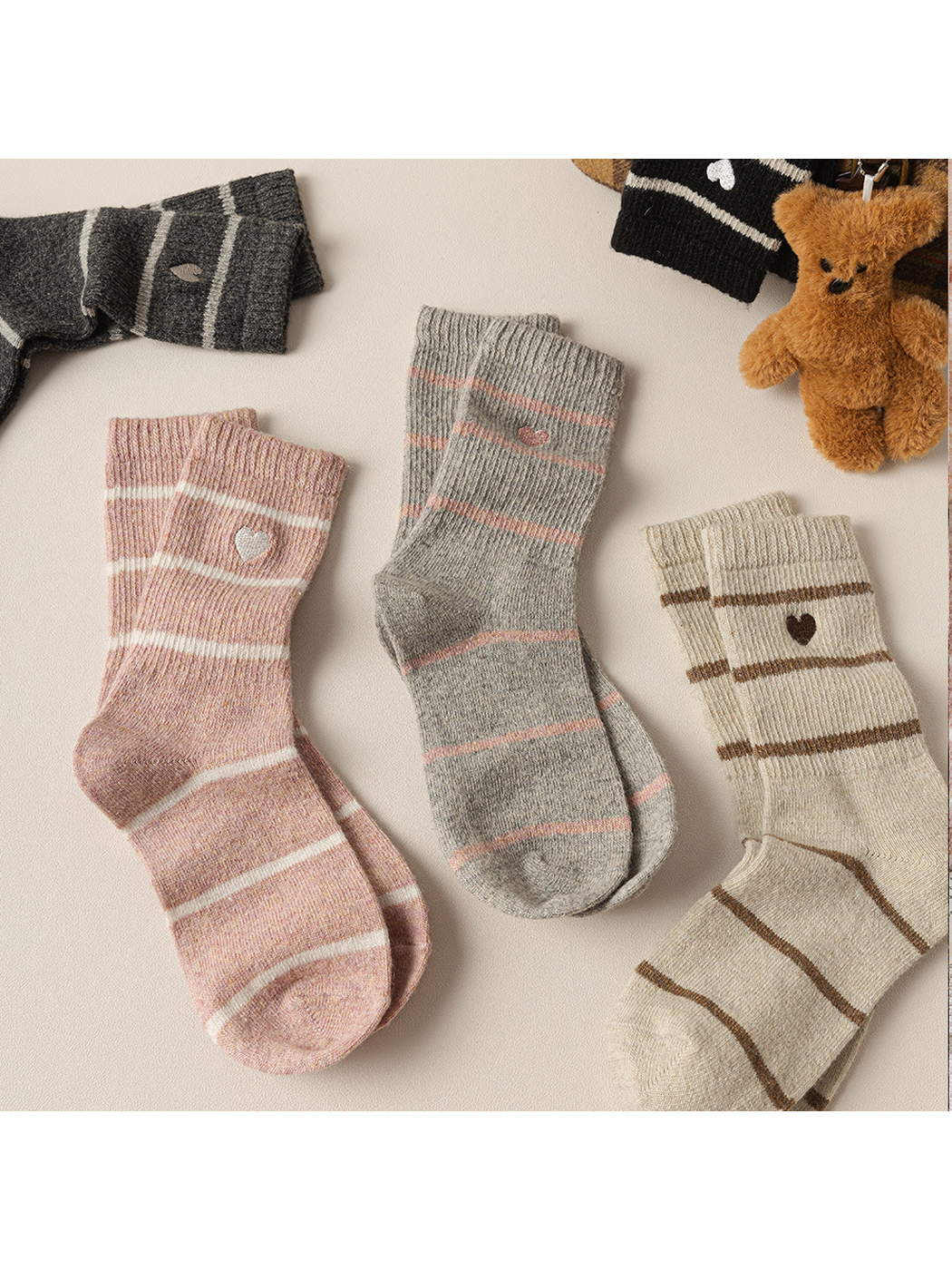 Five striped crew sock colorways with heart motifs displayed together