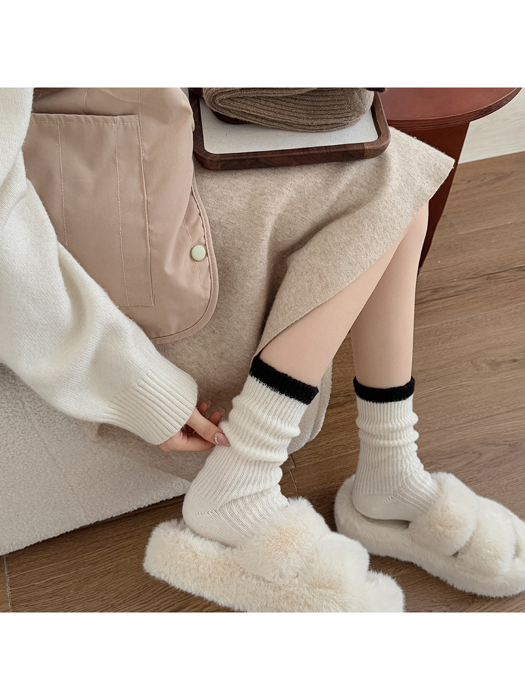 Ivory ribbed crew socks worn with plush slippers