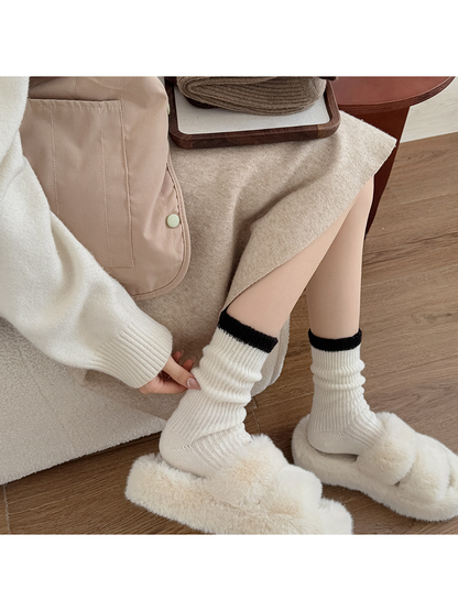 Ivory ribbed crew socks worn with plush slippers