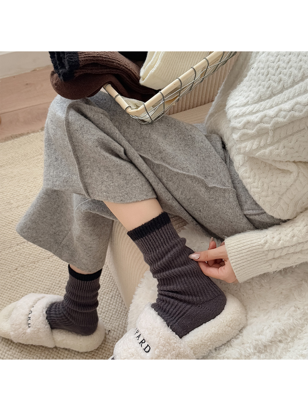 Dark gray ribbed crew socks worn gathered with plush slippers