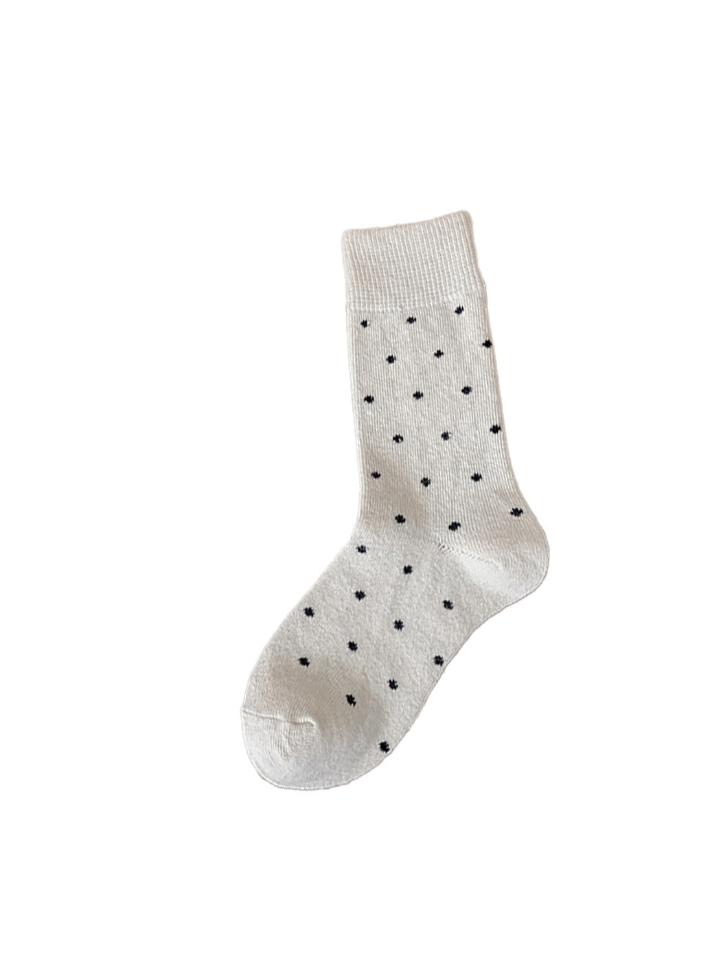 Cream crew sock with black polka dots on a white background