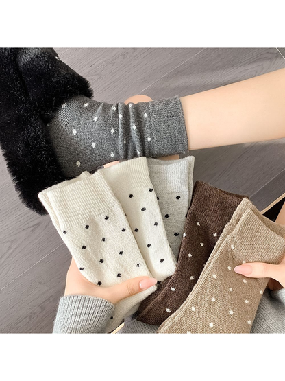 Assorted polka-dot crew socks displayed together in neutral colors