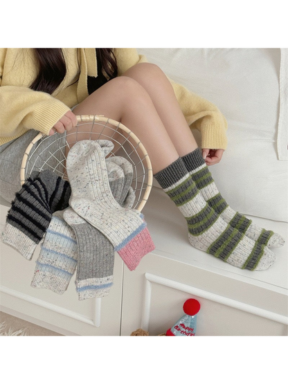 Striped and color-blocked speckled crew socks styled together