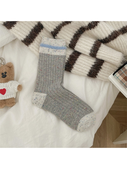 Gray ribbed speckled crew socks with ivory toe, heel and cuff