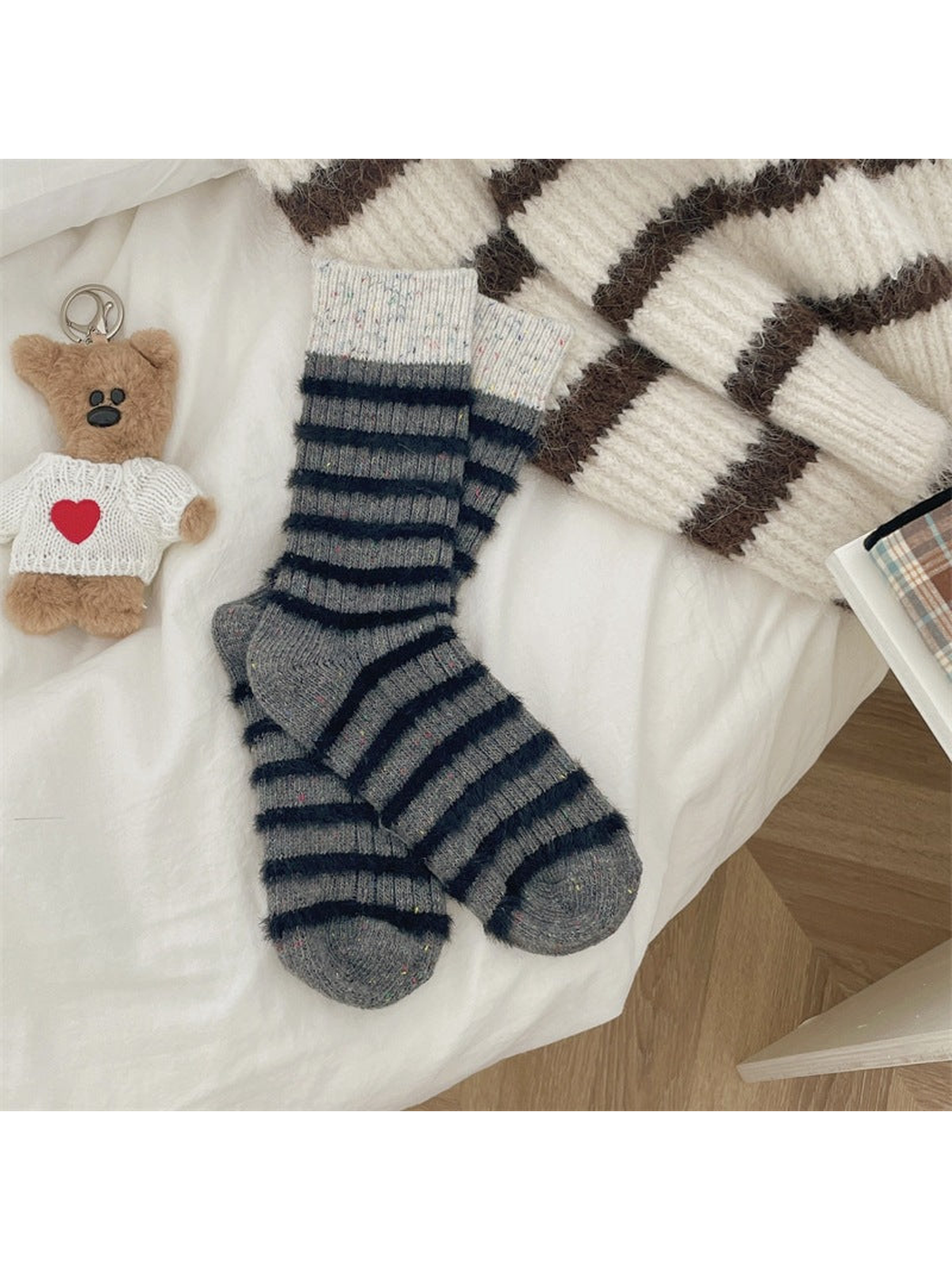 Gray speckled crew socks with narrow black stripes and ivory cuffs