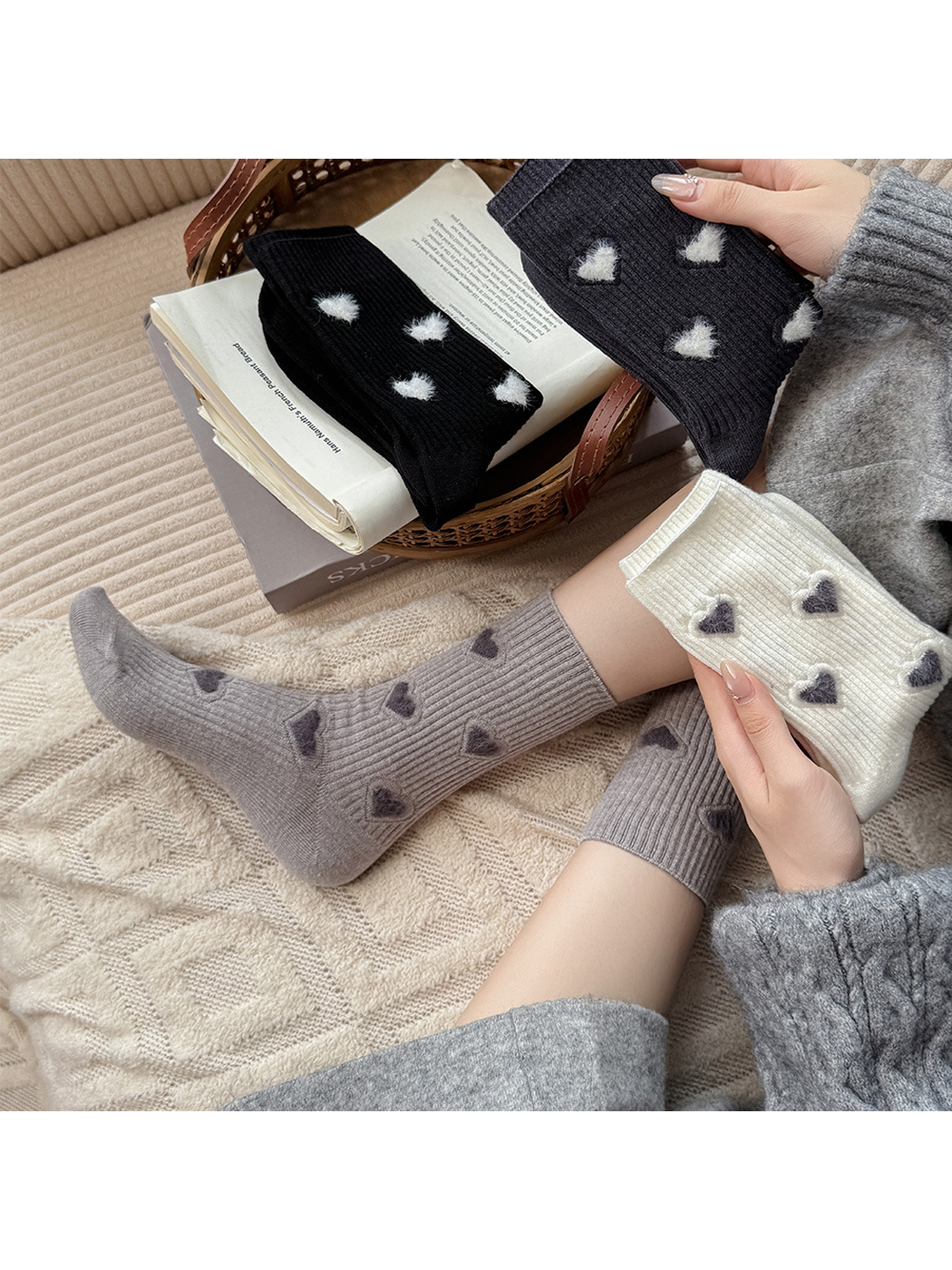 Gray heart-motif crew socks styled with folded ivory, black and dark gray pairs
