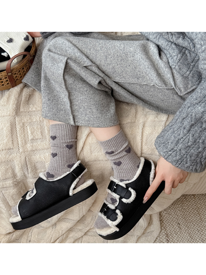 Greige heart-motif crew socks worn with black fleece-trimmed shoes