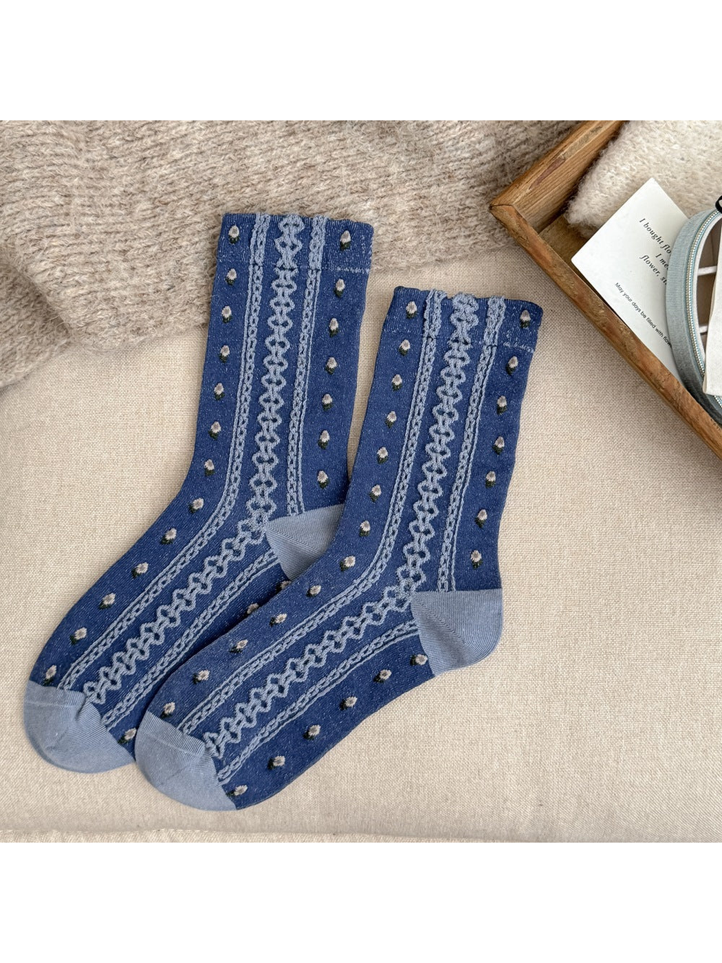 Blue crew socks with floral dots and raised decorative stripes