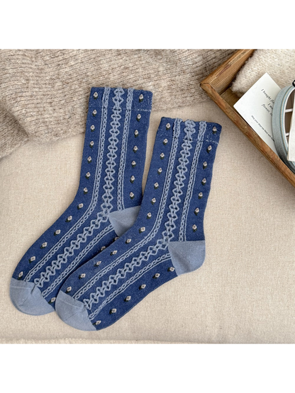 Blue crew socks with floral dots and raised decorative stripes