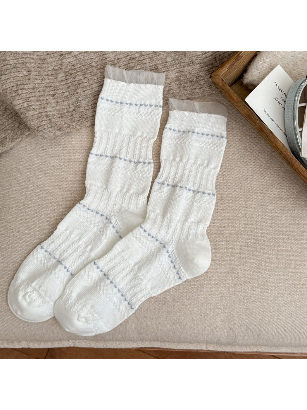 White crew socks with pointelle stripes and sheer ruffle cuffs