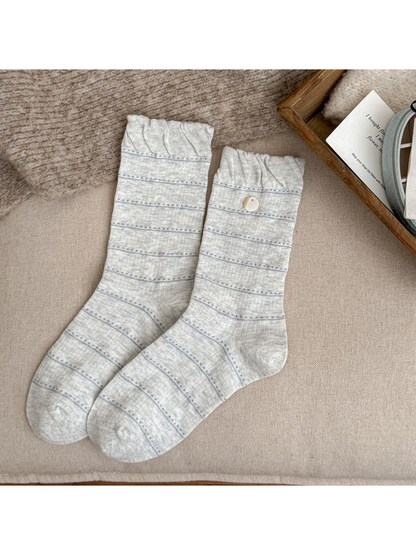 Light gray crew socks with fine stripes, gathered cuffs and buttons